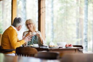 Beautiful mature couple drinking coffee at veranda