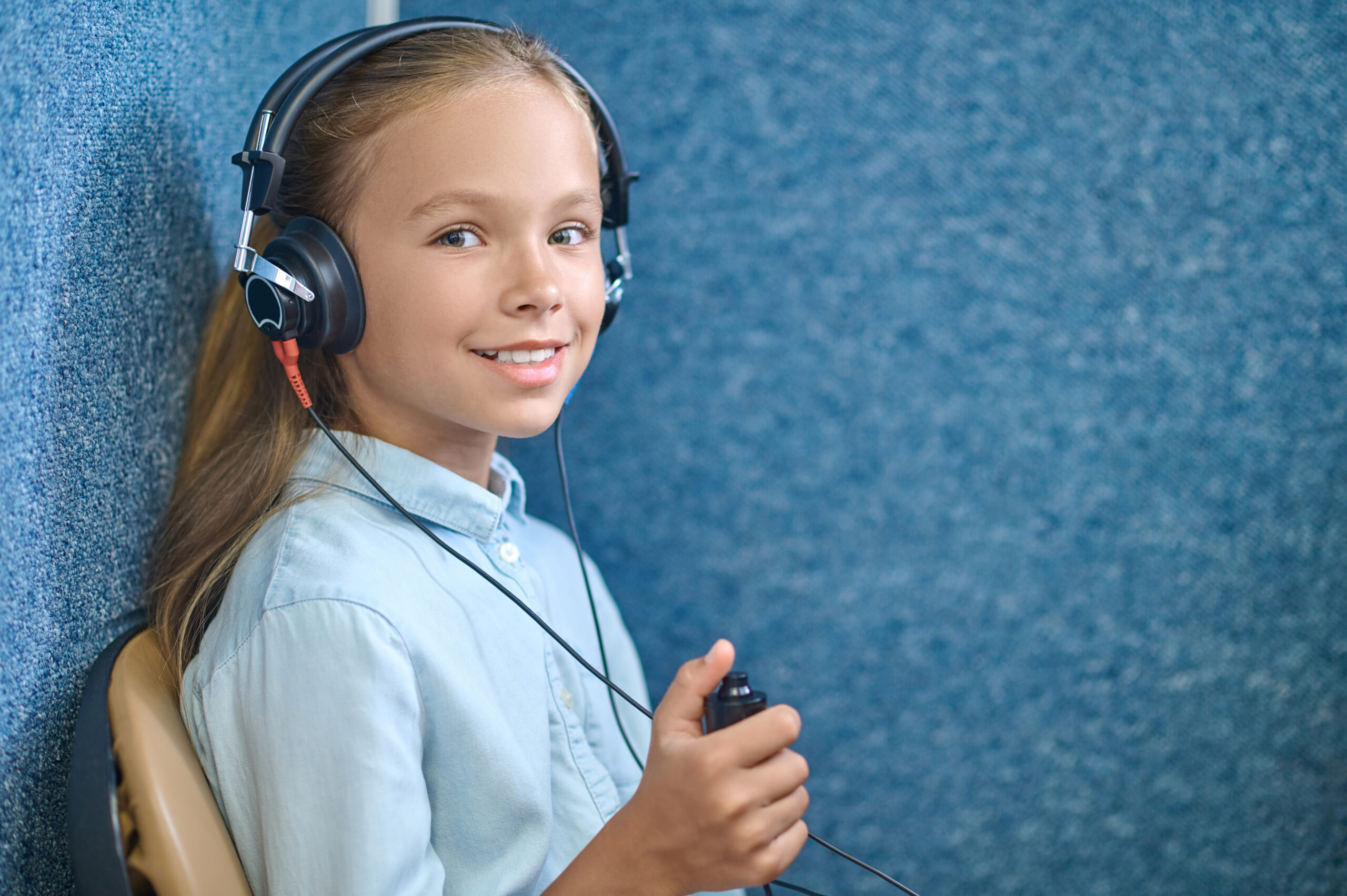Girl in special headphones checking hearing