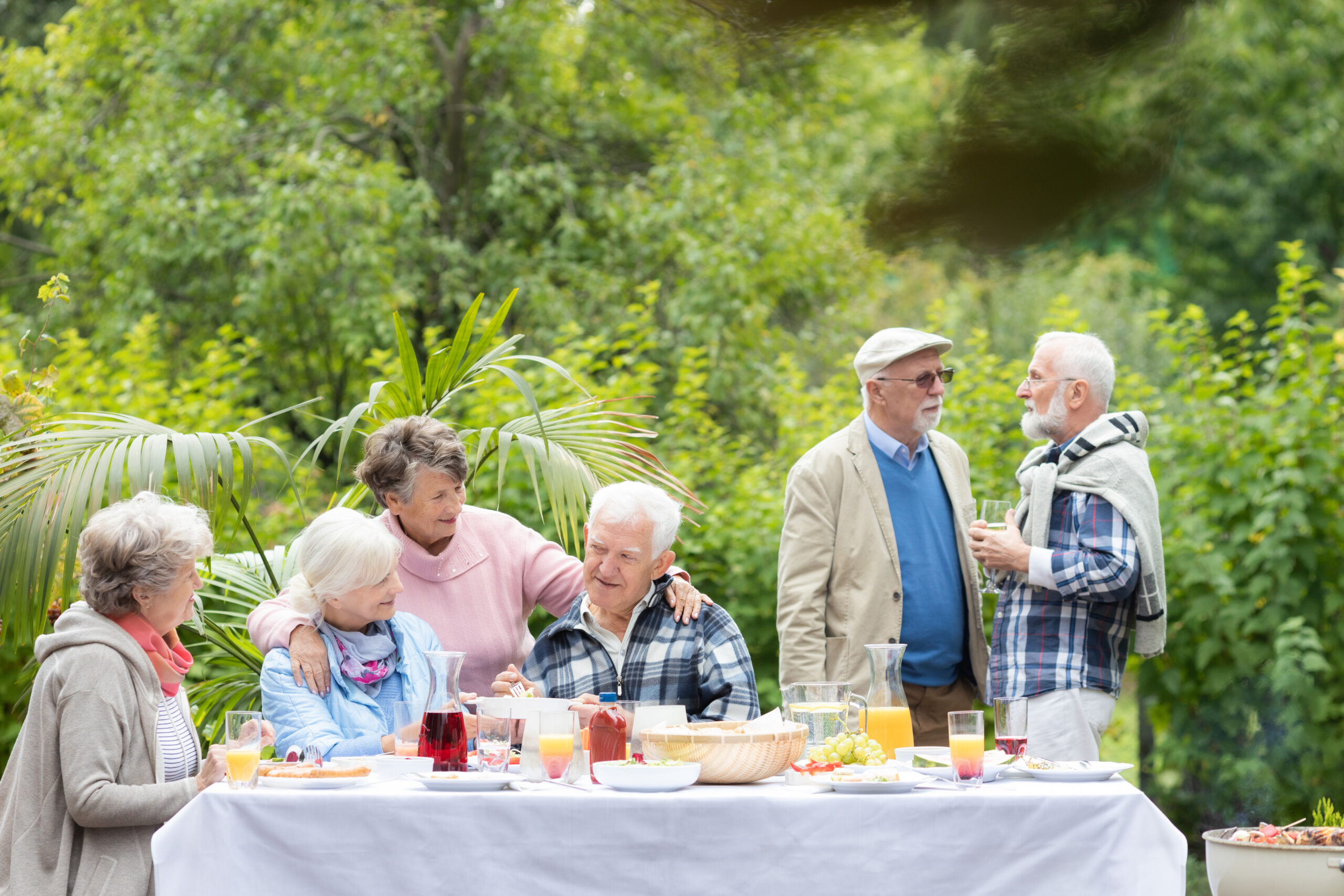 Older friends having fun at the party in the garden