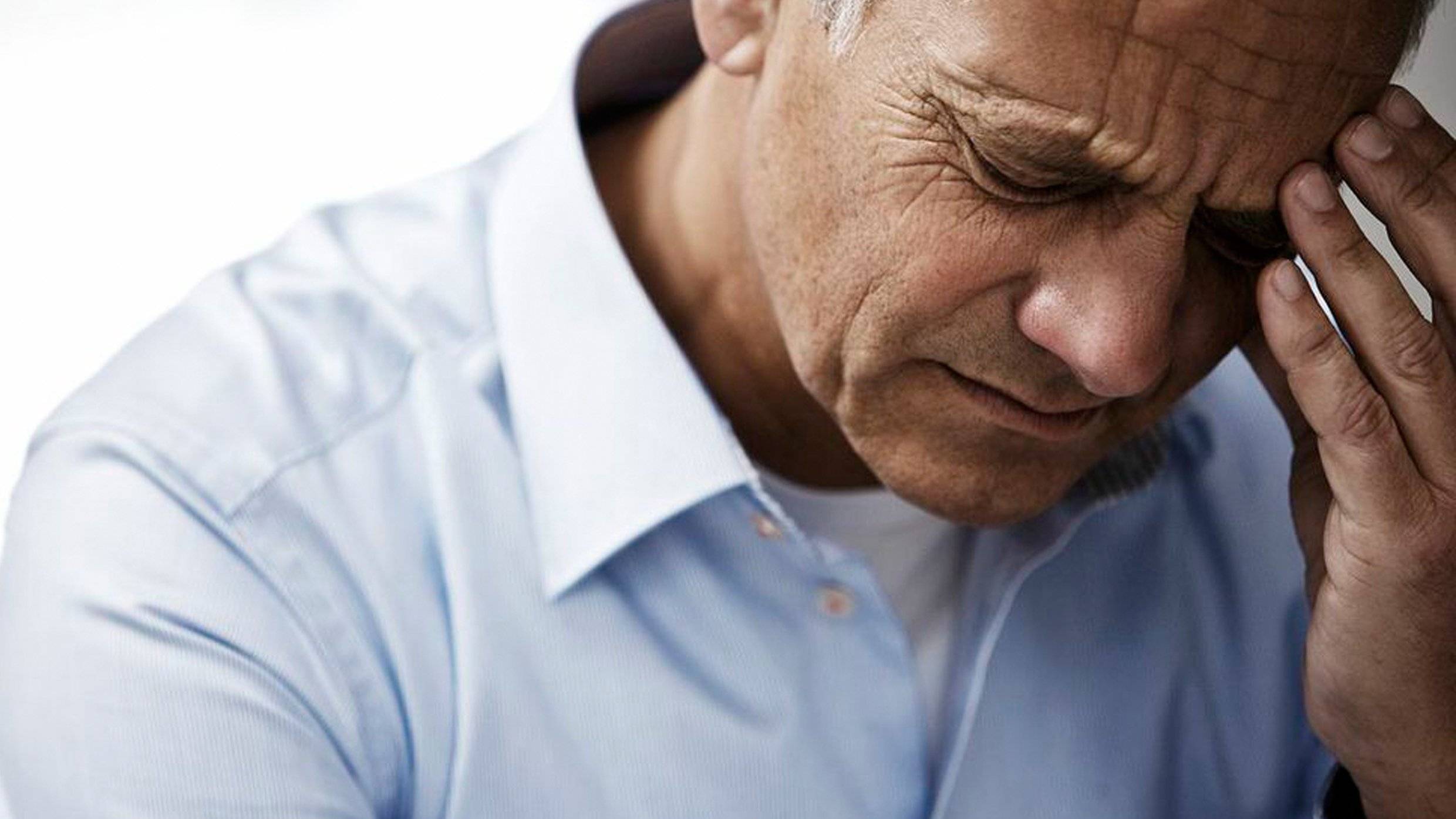 Man holding head with pain in ear