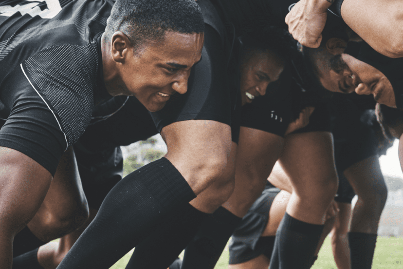 men playing rugby in a scrum, hearing loss and high impact sports risk