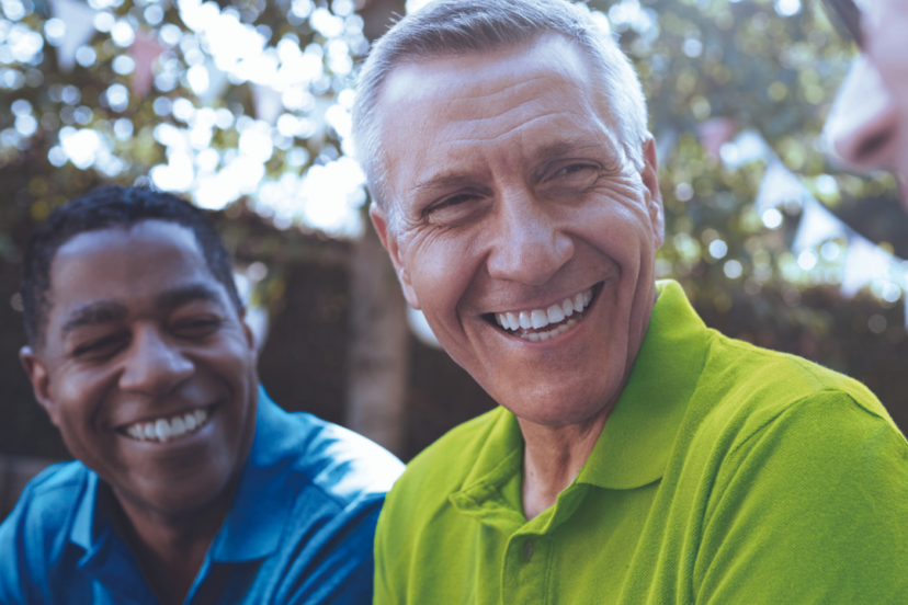 Men outdoors smiling and talking